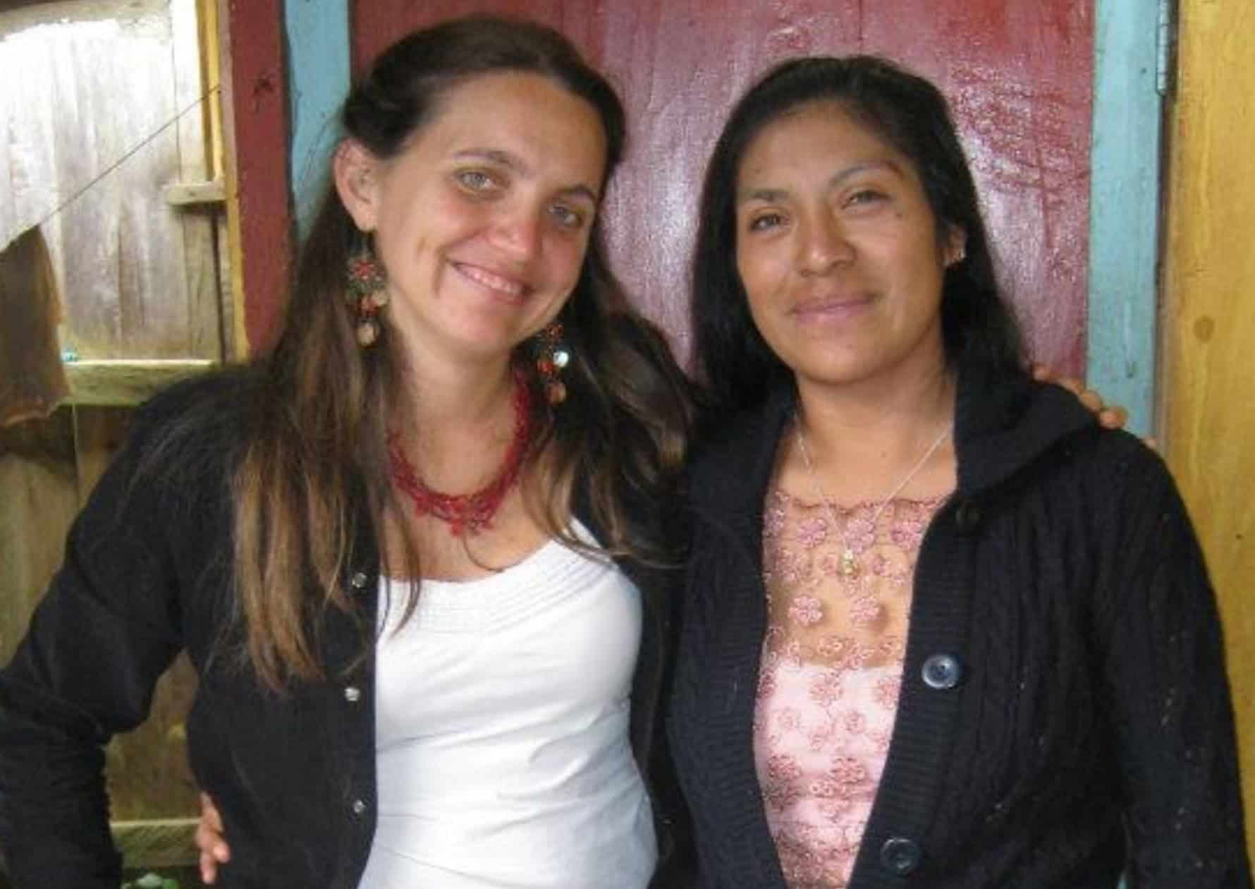 Two women from Ixil community smiling together, promoting empowerment and community development.