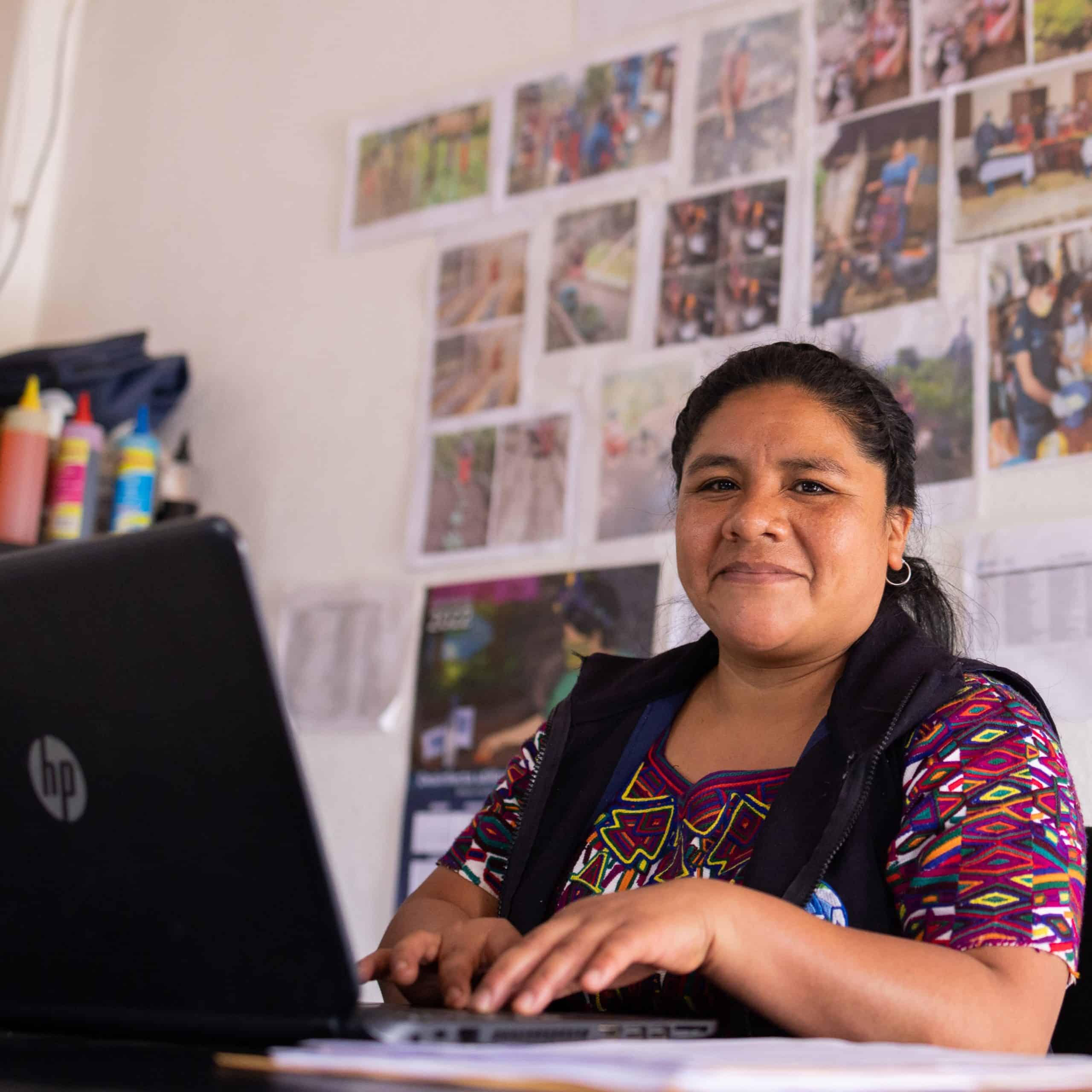 Woman working on a laptop in an educational setting at Limitless Horizons Ixil.