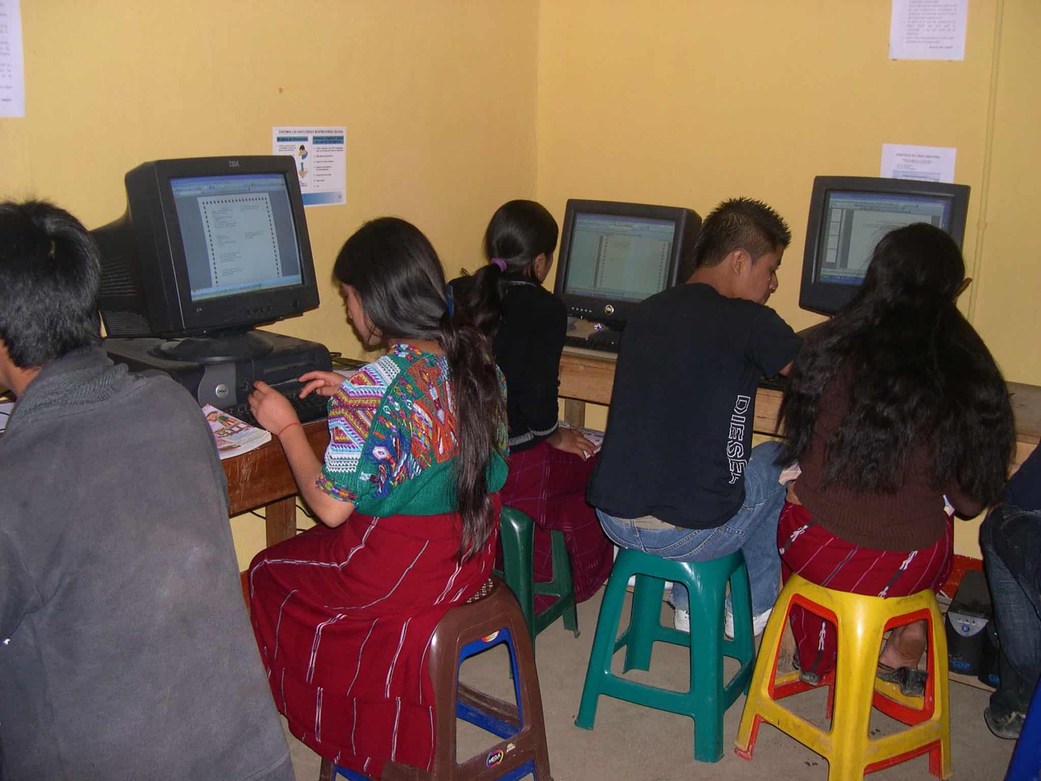 Students working on computers in a classroom setting.