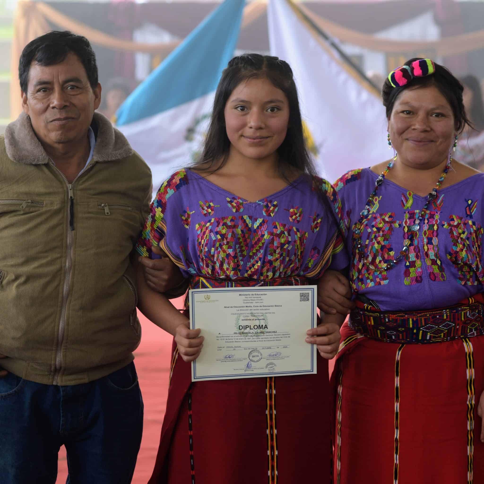 Graduates receiving diplomas during a cultural event promoting education.