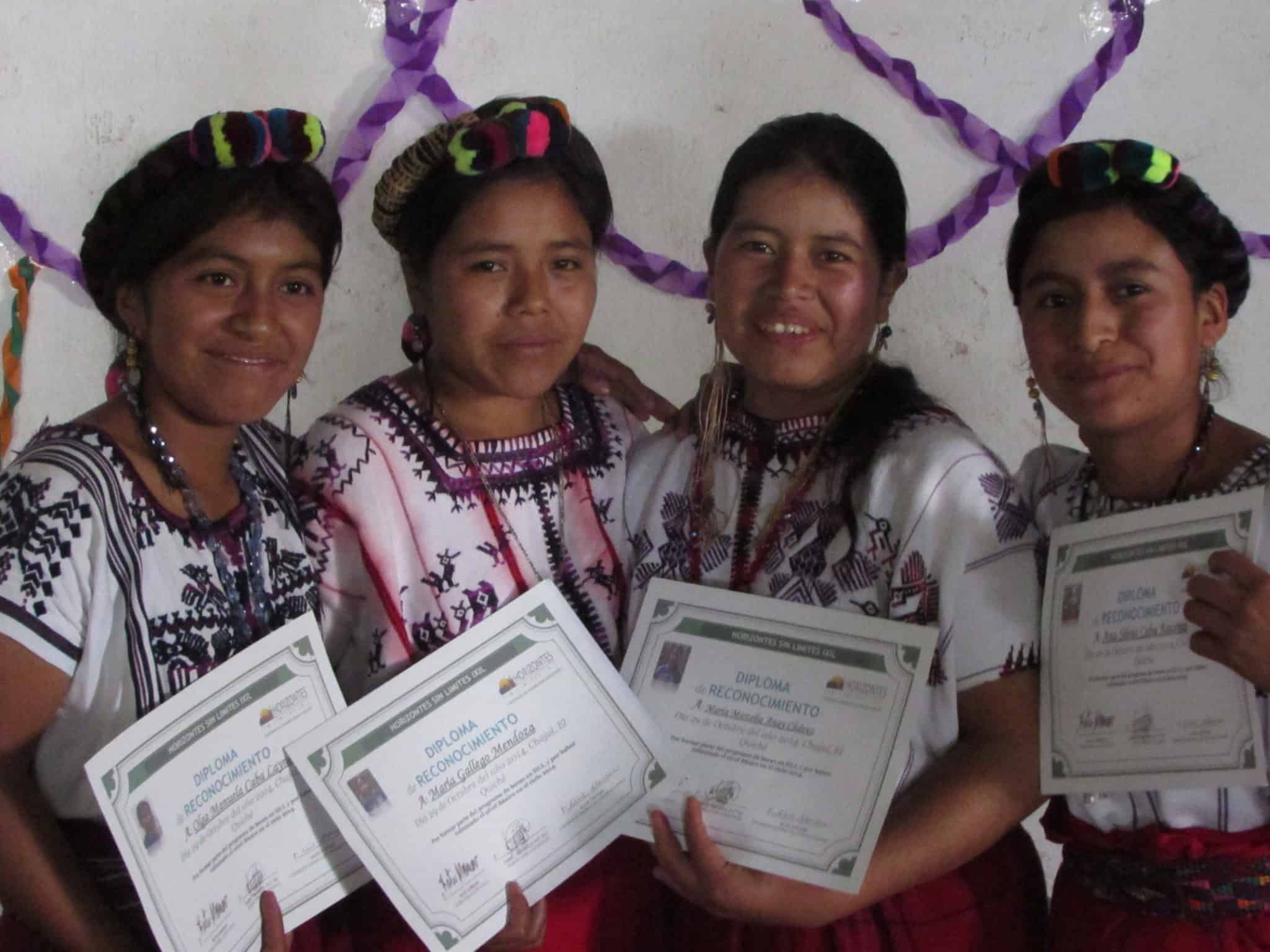 Graduates from Colegio Horizontes with diplomas in Ixil community.